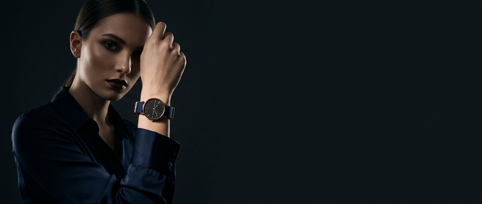 Man in the dark wearing the navy watch